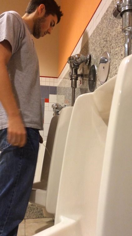 Guy peeing urinal